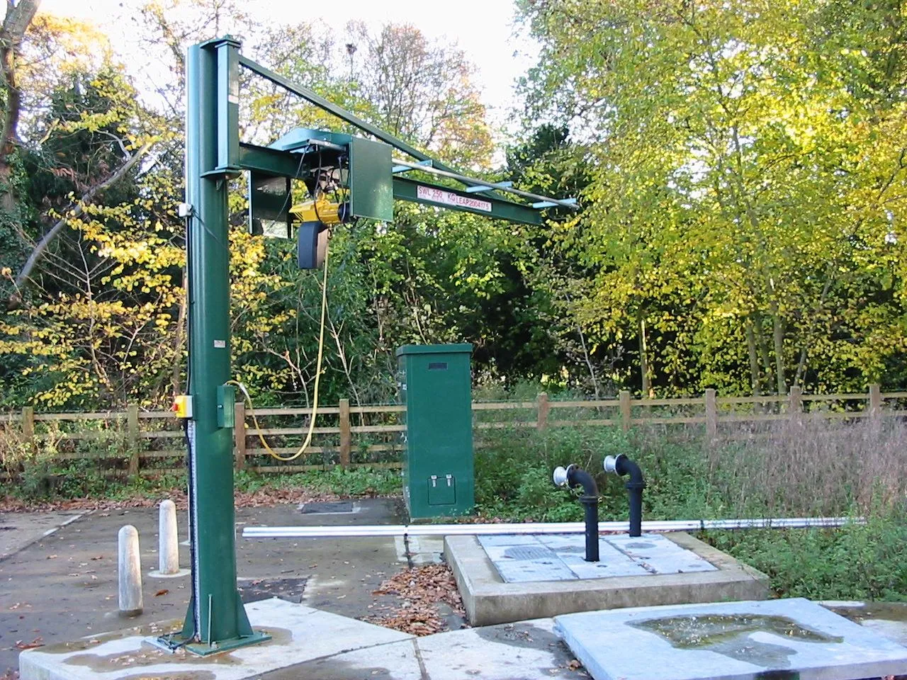 Somers green freestanding pillar jib crane installed at a water-industry pumping station.