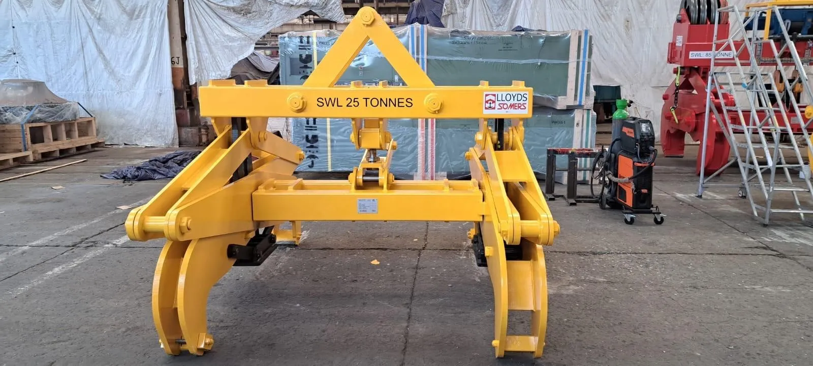 Yellow Lloyds Somers 25-tonne SWL gravity scissor tong photographed at the Somers Wednesbury works.